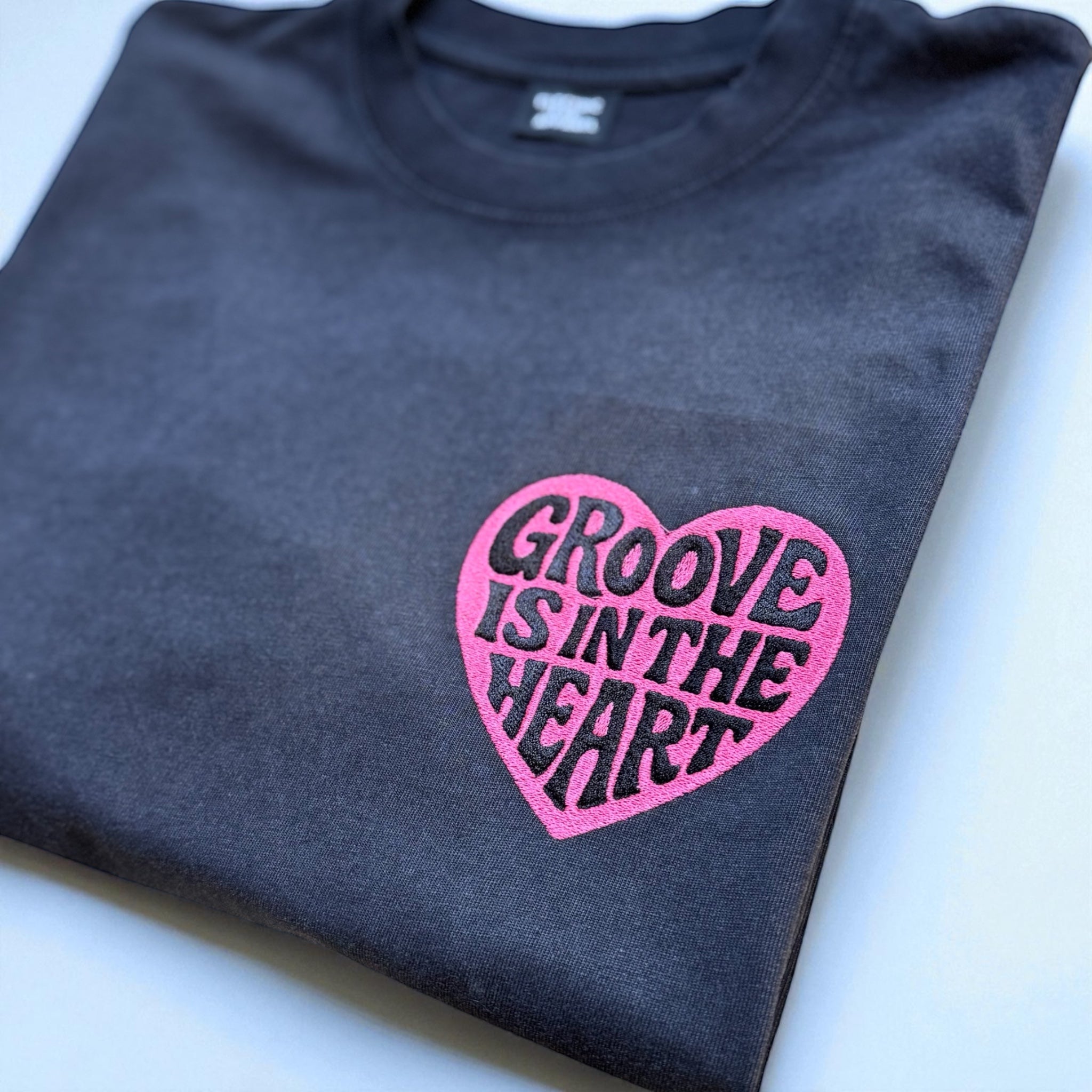 'GROOVE IS IN THE HEART' left chest embroidered premium organic unisex vintage aged t-shirt