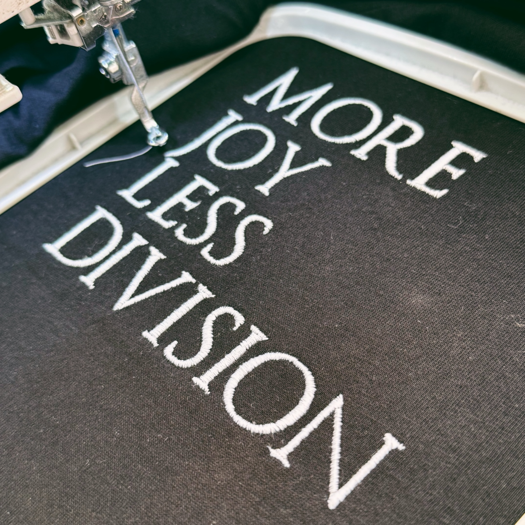 'MORE JOY LESS DIVISION' Left chest embroidered premium organic women's iconic mid-light 'Sienna' t-shirt