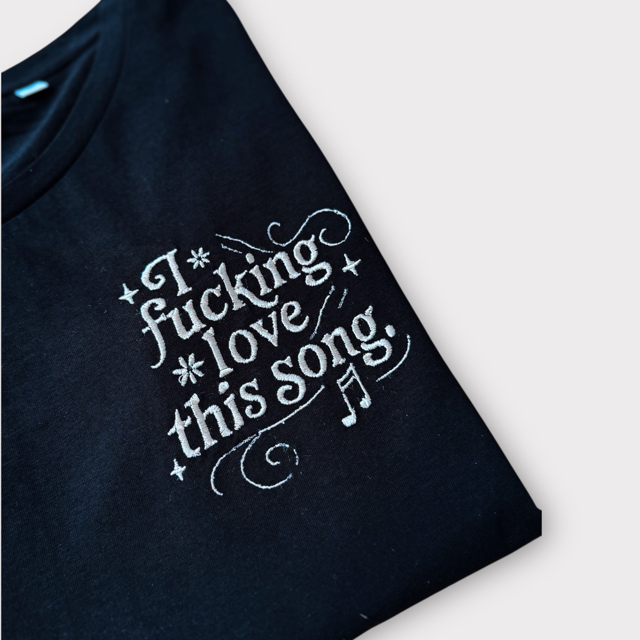 'I FUCKING LOVE THIS SONG' music notes left chest embroidered premium organic iconic mid-light women's 'Serena' t-shirt