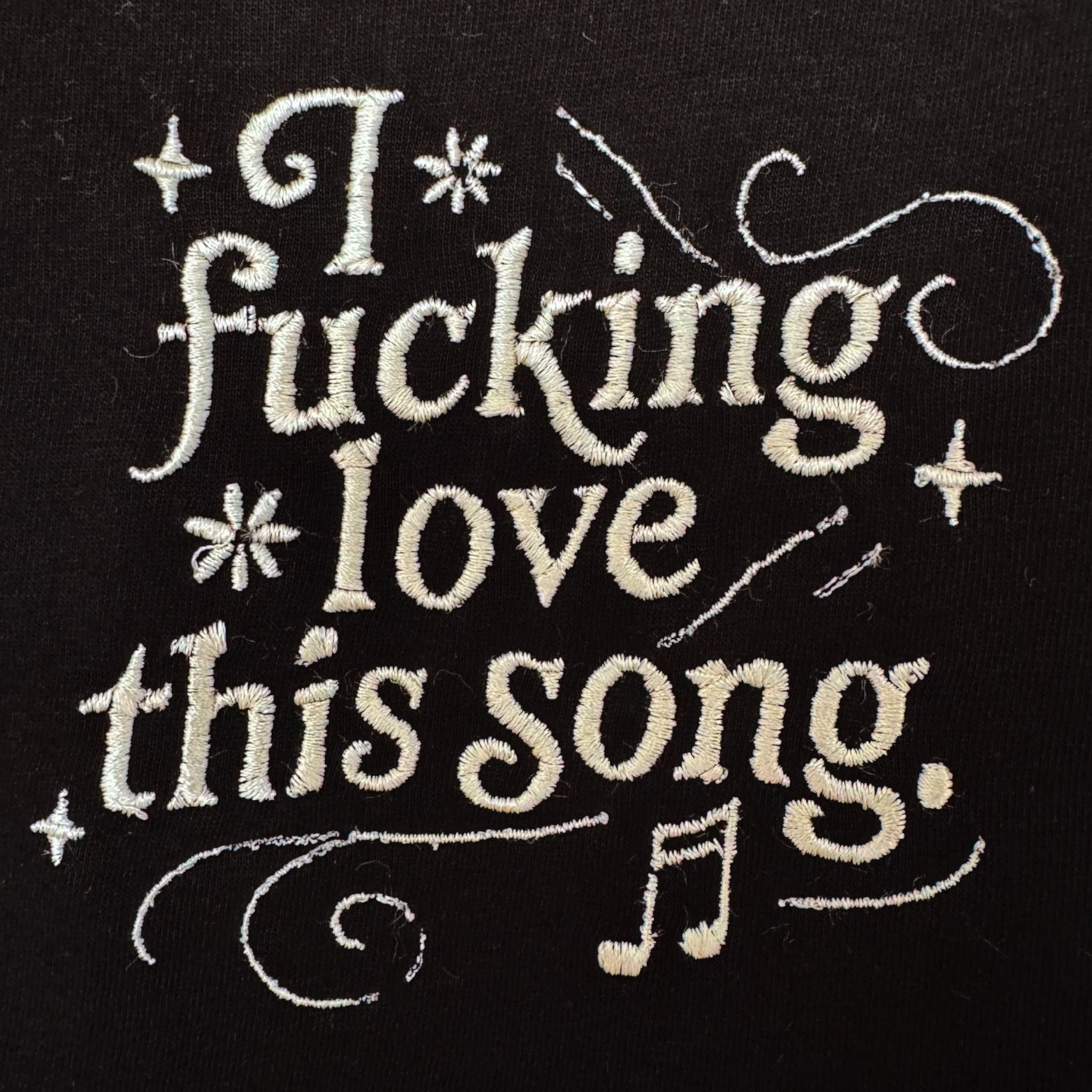 'I FUCKING LOVE THIS SONG' music notes left chest embroidered premium organic iconic mid-light women's 'Serena' t-shirt